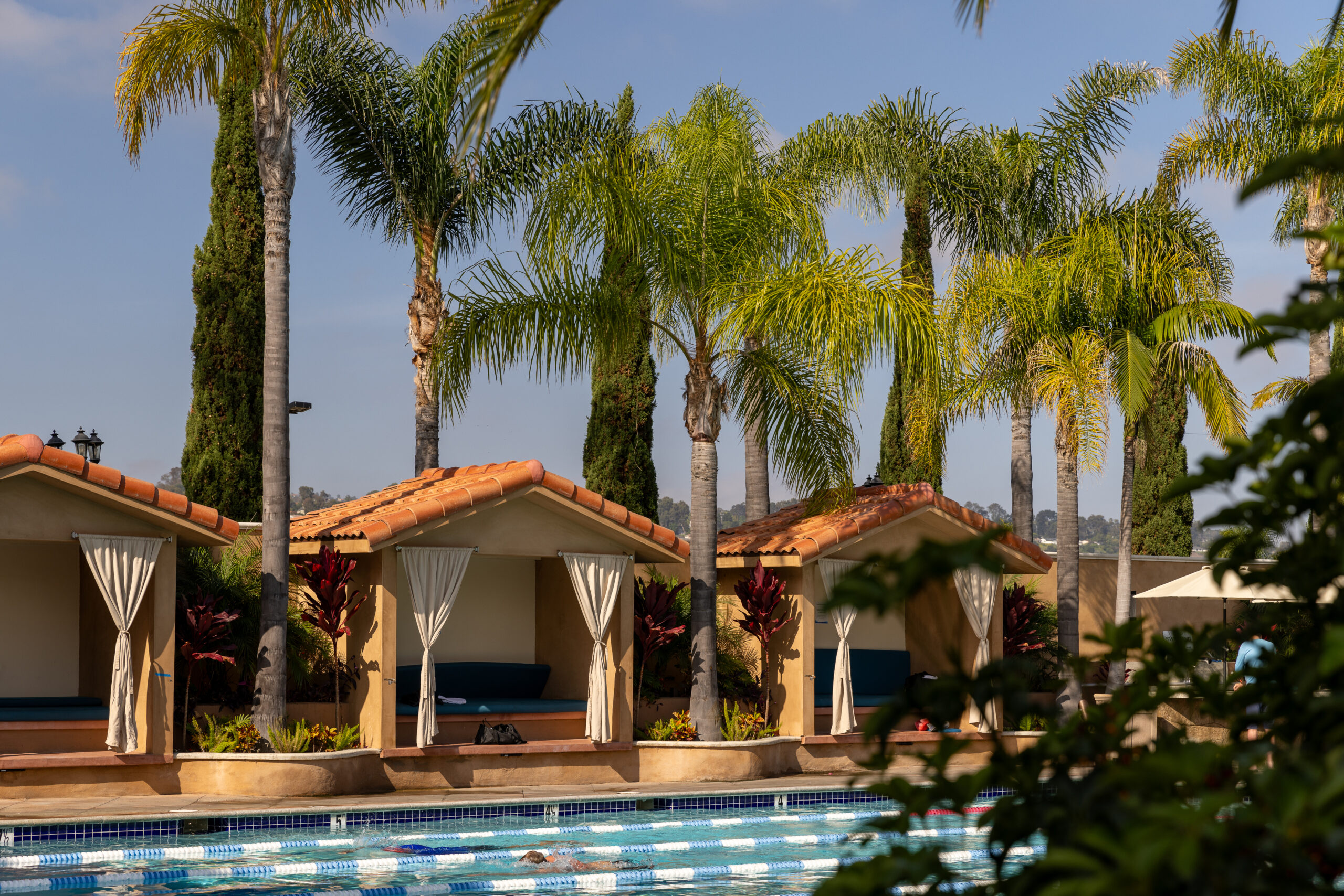 Lap swimming area with private cabanas and tropical landscaping
