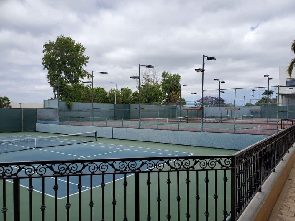 South End's tennis courts seen from the balcony, with light poles above the courts